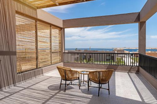 a patio with a table and chairs on a balcony at Sentido Naga Bay - Adults friendly in Hurghada