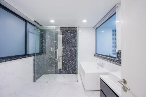 a bathroom with a shower and a sink at My Havana, pool villa in Ban Nong Pru