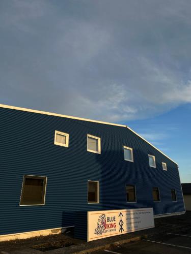 a blue building with a sign in front of it at Blue Viking Guesthouse in Keflavík