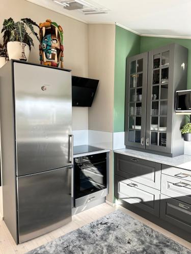 a kitchen with a stainless steel refrigerator at Apartment close to central city in Gothenburg