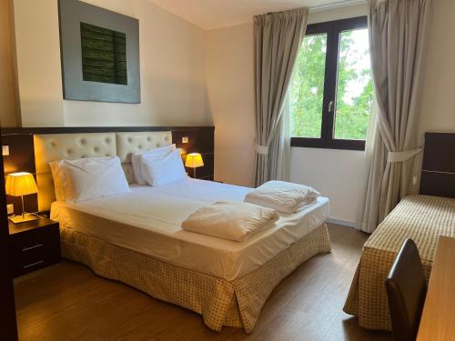 Postel nebo postele na pokoji v ubytování GREEN GARDEN Resort - Smart Hotel