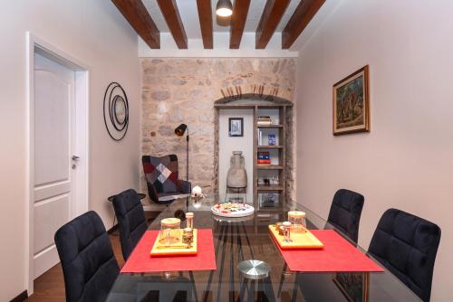a dining room with two red tables and black chairs at Sizgoric Palace Suites Sibenik in Šibenik