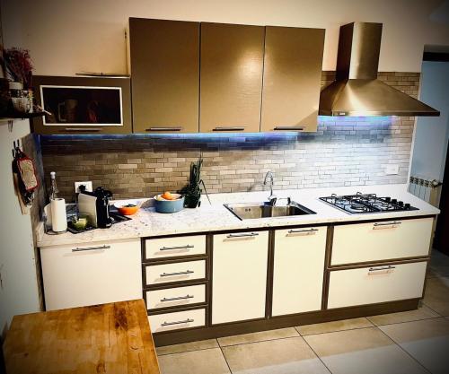 a kitchen with a sink and a stove at Kasavale in Ortonovo