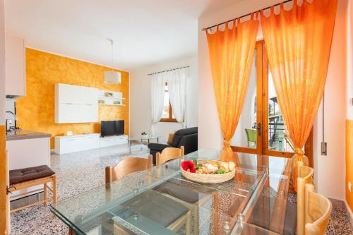 a living room with a glass table with a bowl of fruit on it at Casa Oro -Pula Terrace and Wifi near downtown in Pula