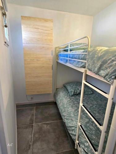Cette petite chambre comprend 2 lits superposés et un placard. dans l'établissement La Baie - Studio neuf avec balcon vue mer, à 5min de la mer avec parking - By AURAconciergerie, à La Ciotat