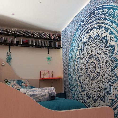 a bedroom with a wall with a large mural at IL FARO Comfort a 500 m dal mare in Casa Borgorosso