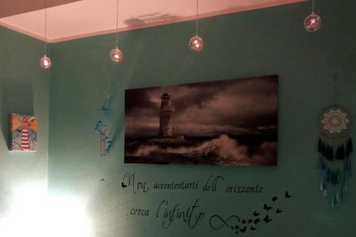 a wall with a picture of a lighthouse on it at IL FARO Comfort a 500 m dal mare in Casa Borgorosso