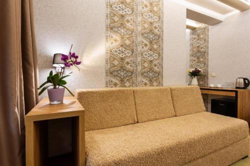 a living room with a couch and a table at SPA Hotel Olymp in Velingrad