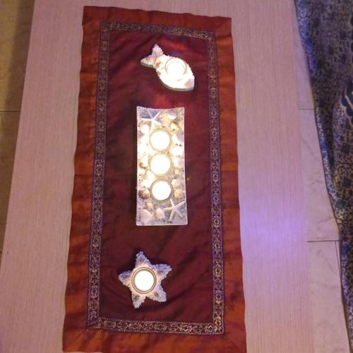 a table with two candles and a candle holder on it at IL FARO Comfort a 500 m dal mare in Casa Borgorosso