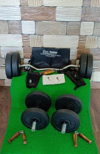 a cake of a race car with weights on a green floor at Kalwars Millennials Park in Karjat