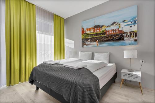 a bedroom with a large bed with green curtains at Iceland Comfort Apartments by Heimaleiga in Reykjavík