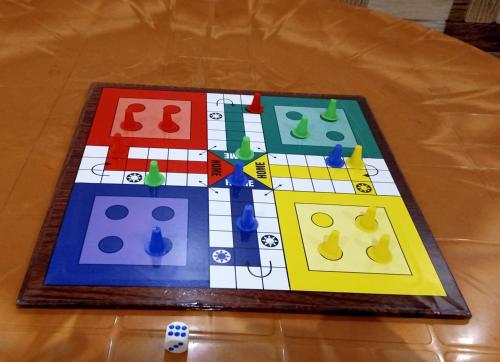 a chess board on a wooden table with a chessboard at Kalwars Millennials Park in Karjat