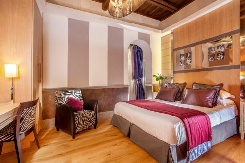 a bedroom with a bed and a desk and a chair at The Inn at the Spanish Steps Luxury Collection - The Inn at the Spanish Steps in Rome