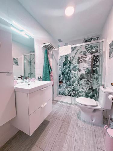 a bathroom with a shower and a sink and a toilet at Casa rosa completa-patio- BBQ-columpios-buhardilla in Campillo de Altobuey