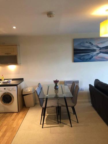 a living room with a table and a couch at Solihull Centre Apartments in Solihull