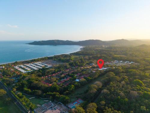 an aerial view of a beach with a red marker at 8-min Walk to Beach with Pool & Golf in Pochote