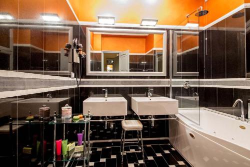 a bathroom with two sinks and a mirror at The Inn at the Spanish Steps Luxury Collection - The Inn at the Spanish Steps in Rome