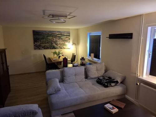 a living room with a white couch and a table at FeBo am Wolfsgarten in Bad Harzburg