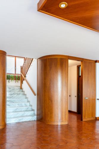 a hallway with a staircase in a house at Exclusive Villa with Lake view-Private SPA in Galbiate