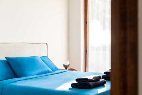 a bed with blue sheets and towels on it at Exclusive Villa with Lake view-Private SPA in Galbiate