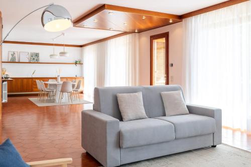 a living room with a couch and a dining room at Exclusive Villa with Lake view-Private SPA in Galbiate