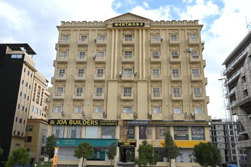 een groot gebouw met een bord erop bij Just Move Premium 2BR Suite, Near ISB Int'l AIRPT in Islamabad