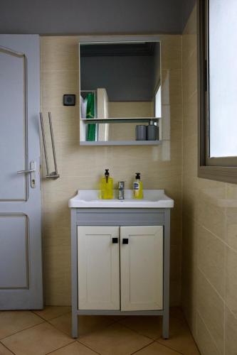 a bathroom with a white sink and a mirror at Tasra Surf Paradise, Imsouane in Imsouane