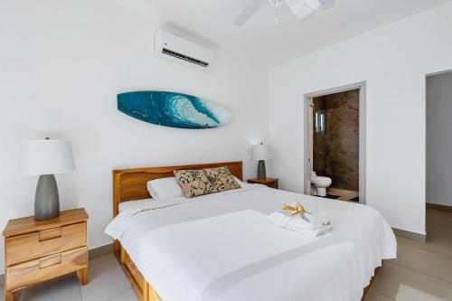 a bedroom with a large bed and a nightstand with a blue fish above it at Casa Anbara Private Pool in Pochote