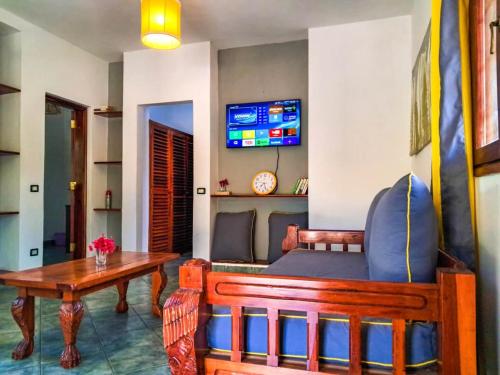 a living room with a couch and a table at Modern Girasoli Suites 08 in Malindi