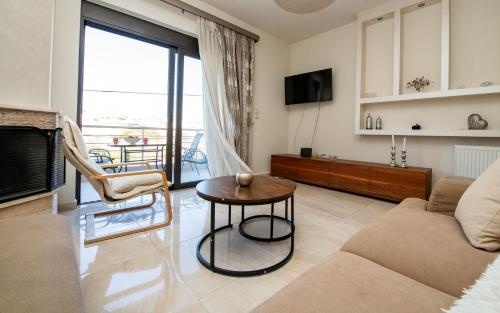 a living room with a couch and a table at Xristina Home in Afantou