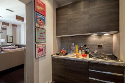 a kitchen with brown cabinets and a counter with food at The Inn at the Spanish Steps Luxury Collection - The Inn at the Spanish Steps in Rome