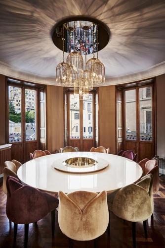 a dining room with a white table and chairs at The Inn at the Spanish Steps Luxury Collection - The Inn at the Spanish Steps in Rome