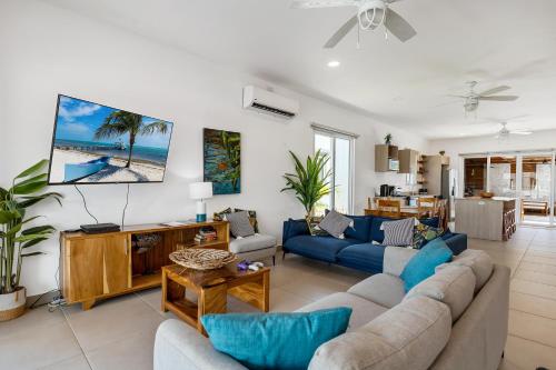 a living room with a blue couch and a table at Casa Anbara Private Pool in Pochote