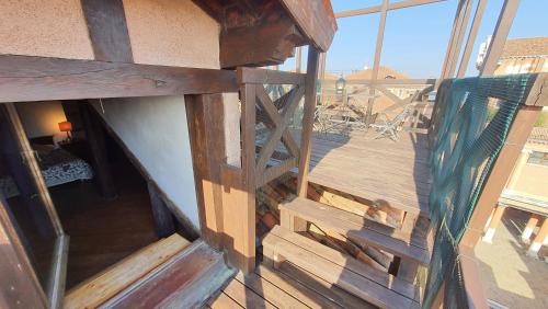 an overhead view of a balcony with a wooden stairs at Palazzo Contarini Della Porta Di Ferro in Venice