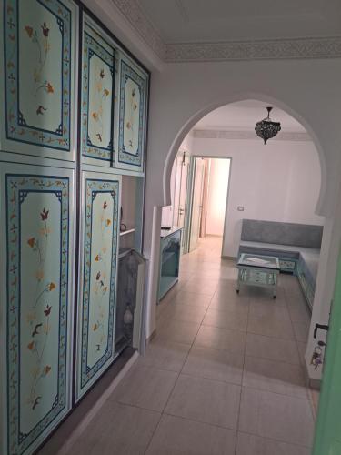 a living room with a wall with floral wallpaper at villa izabelles in Djerba
