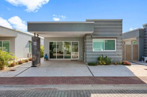 a house with a person walking in front of it at Casa Anbara Private Pool in Pochote