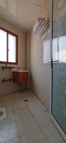 a bathroom with a shower and a sink at 建水县井宿客栈 in Jianshui