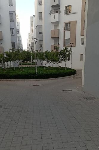 a street with trees in front of a building at Anza Miftah Sahel in Agadir