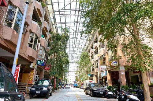 an empty street with cars parked in the middle of buildings at EG Hostel in Nantou City