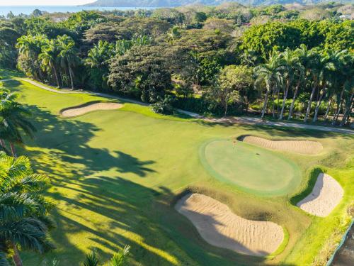 an aerial view of a golf course with palm trees at Casa Anbara Private Pool in Pochote