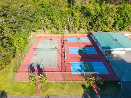 an overhead view of two tennis courts with trees at Casa Anbara Private Pool in Pochote