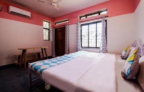 a bedroom with a large bed and a window at Star Home in Anjuna
