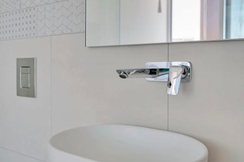 a bathroom with a white toilet and a sink at Seaview Luxury Villa Jacuzzi & Pool! 2 Min Beach in Protaras