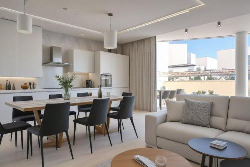 a living room with a couch and a table and chairs at Seaview Luxury Villa Jacuzzi & Pool! 2 Min Beach in Protaras