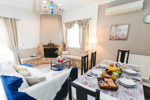a living room with a dining room table and a couch at Villa Irene, Lindos 10 mins, beach 4 mins in vlicha