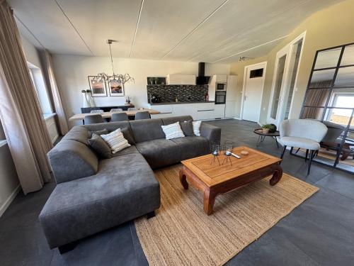 a living room with a couch and a table at Vakantiehuis centrum Lemmer in Lemmer