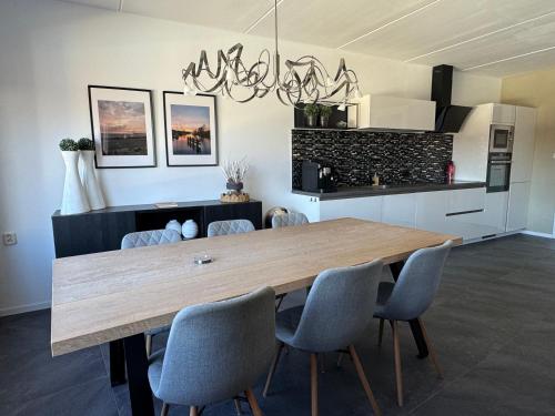 a dining room with a wooden table and chairs at Vakantiehuis centrum Lemmer in Lemmer