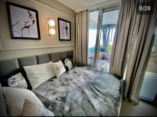 a bedroom with a bed and a window at Sunny Home Costa Plana-Monaco -Cap D'Ail in Cap d'Ail