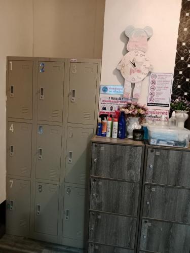 a row of lockers in a room with a wall at STPhostel in Patong Beach