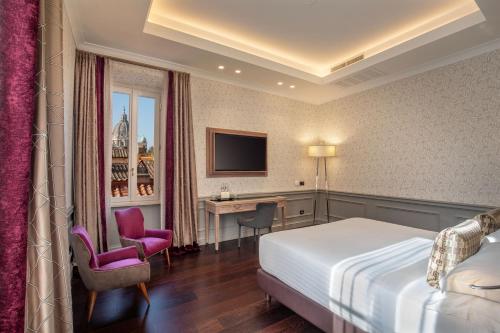 a hotel room with a bed and a desk at The Inn at the Spanish Steps Luxury Collection - The Inn at the Spanish Steps in Rome